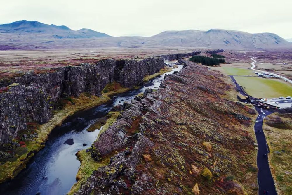 Iceland for Homeschoolers: A Complete Curriculum on Wheels aerial view of Þingvellir rift valley, iceland, showing the almannagjá fault and the visitor area of the althing historical site.