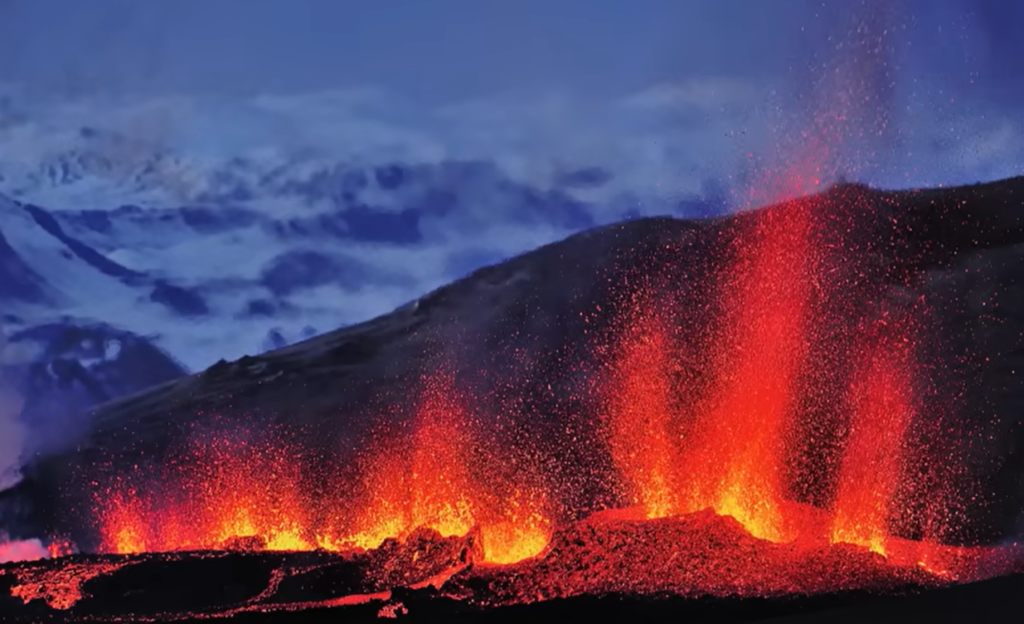 Iceland's Volcanoes: A Beginner's Guide To Reading Earth's Fire Orange lava fountains erupting from a fissure on Reykjanes Peninsula at night, Iceland