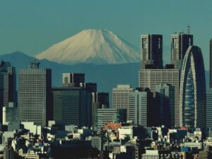 Tokyo’s high‑rise skyline with Mount Fuji rising snow‑capped beyond the city.