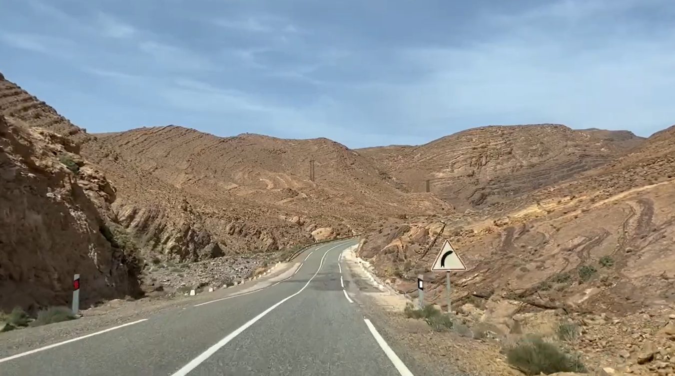 Anti-Atlas geology: serpentine road climbing through a sandstone gorge