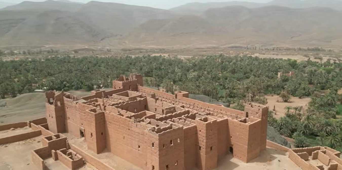 Anti-Atlas geology: aerial view of a Berber kasbah and palm grove in the Ameln Valley