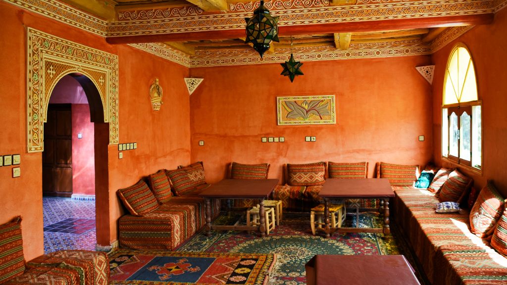 Interior of a traditional Berber salon with tadelakt walls and hand-woven textiles in the Anti-Atlas, Morocco