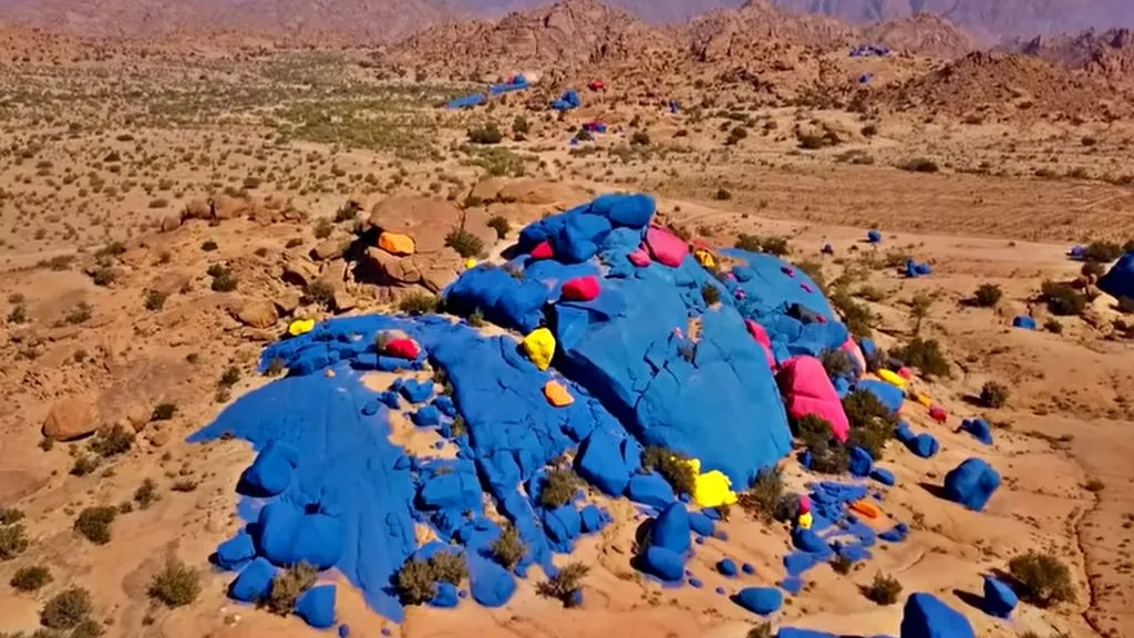 Aerial view of the Painted Rocks near Tafraoute showing the full blue, yellow, and pink painted boulder field