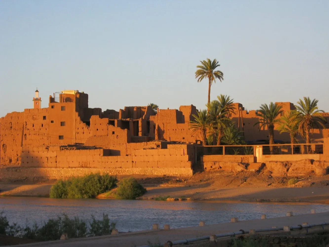 Mudbrick kasbah ruins at Zagora on the Draa river at sunset
