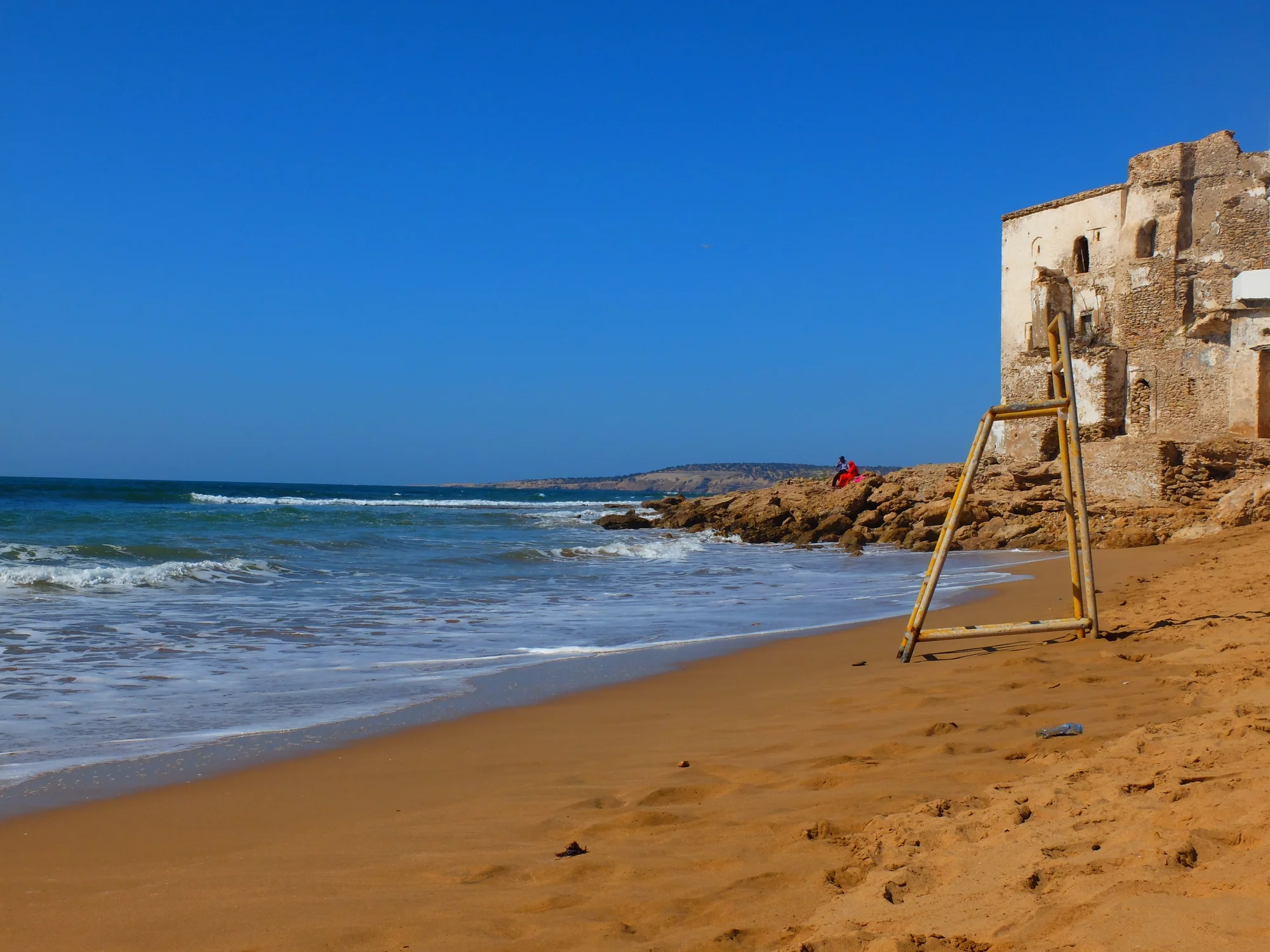 Cretaceous sandstone cliffs at Sidi Kaouki south of Essaouira, showing the harder older rock that resists Atlantic erosion.