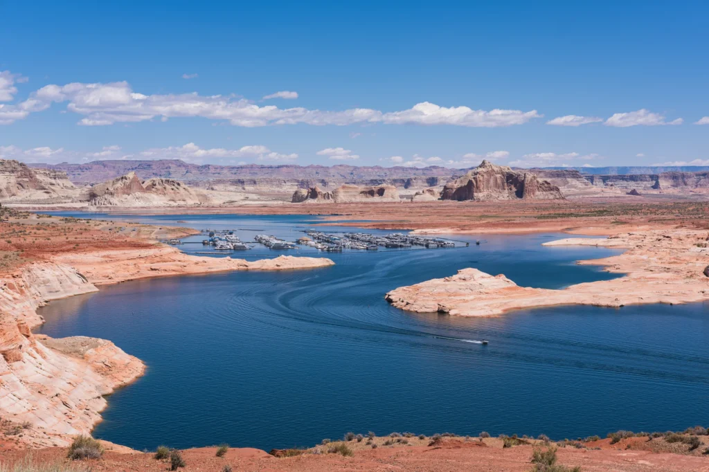 Aerial view of Lake Powell from Wahweap Overlook near Page Arizona, with the Glen Canyon sandstone cliffs rising from the turquoise water
